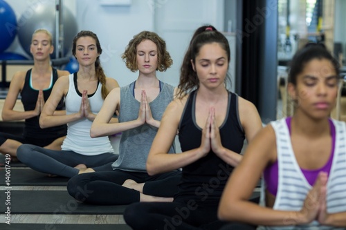 Group of women performing yoga