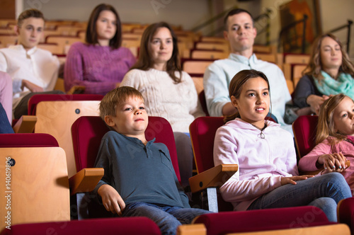Group of people watching movie attentively