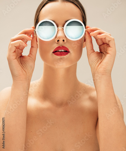 Shirtless female model wearing sunglasses