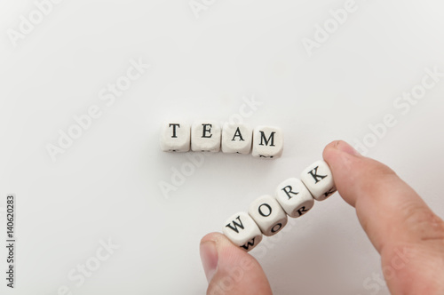 Man hold word Work near word Team spelled by dices