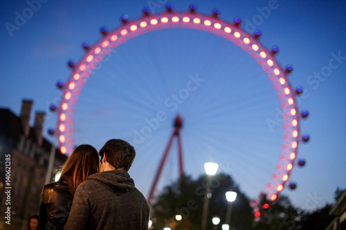 Couple under London eye at night