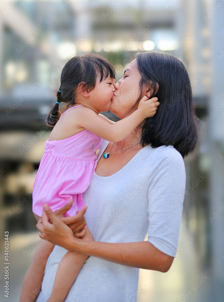 Happy loving family. mother and child girl kissing and hugging Happy loving family. mother and child girl kissing and hugging