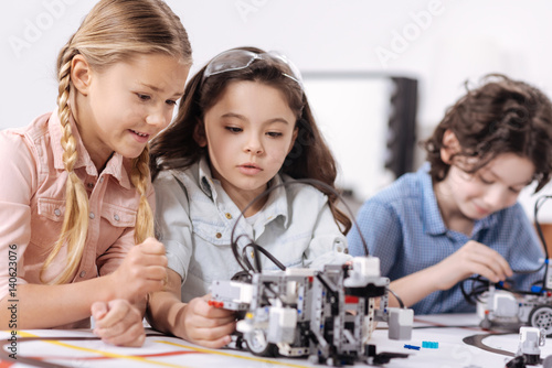 Pleasant children discussing science at school