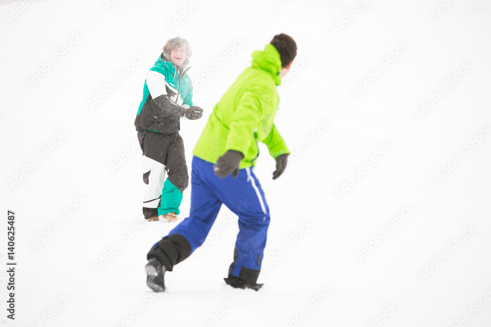 Full length of friends having snowball fight Full length of friends having snowball fight