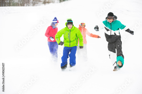 Full length of young friends having fun in snow