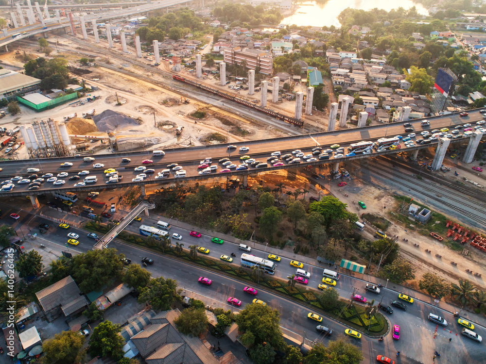 Traffic jam in rush hour,expressway. Freight and passenger train waiting at the train station parking lot.Cargo transit.import export and business logistic.Aerial view.Top view. Railway construction