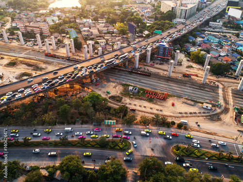 Traffic jam in rush hour,expressway. Freight and passenger train waiting at the train station parking lot.Cargo transit.import export and business logistic.Aerial view.Top view. Railway construction