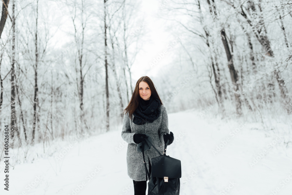 Portrait of a brunette wearing glasses and a gray coat Portrait of a brunette wearing glasses and a gray coat