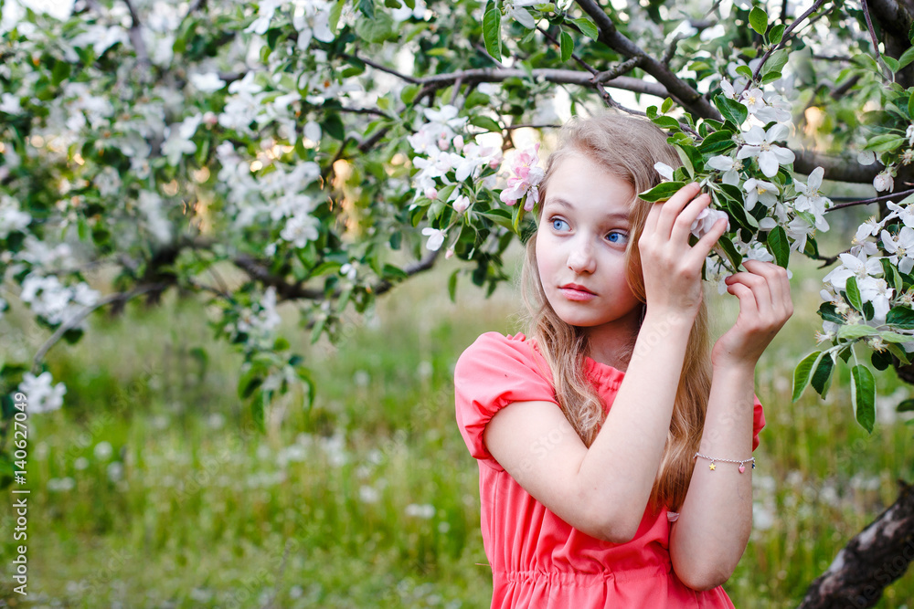 Cute little girl with bunch of lilac near apple trees in blossom at sunset. Kid enjoying happy childhood. Family, love, peace and happiness concept Cute little girl with bunch of lilac near apple trees in blossom at sunset. Kid enjoying happy childhood. Family, love, peace and happiness concept