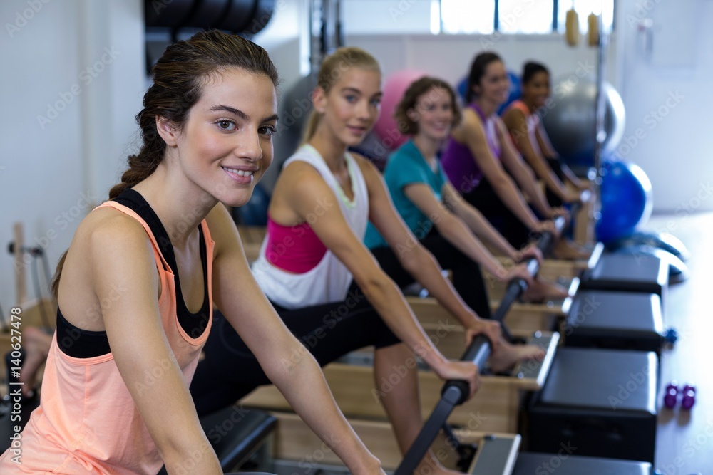 Group of women exercising on reformer Group of women exercising on reformer