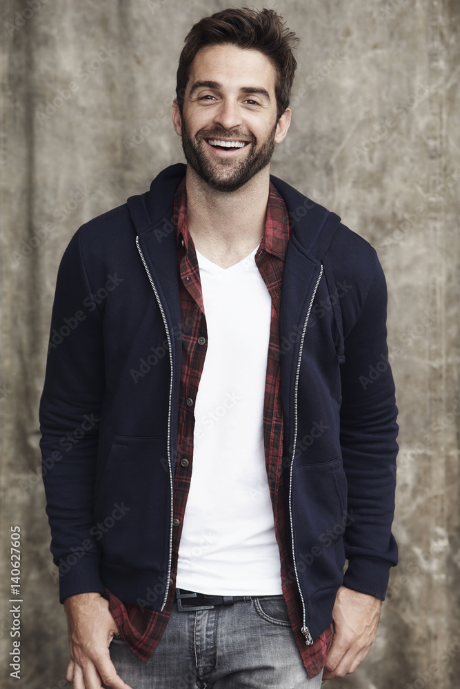 Smiling hoodie guy in studio, portrait Smiling hoodie guy in studio, portrait