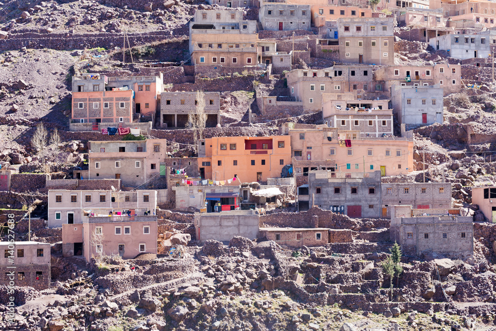 Modest traditional berber village with cubic houses in Atlas mountains, Morocco