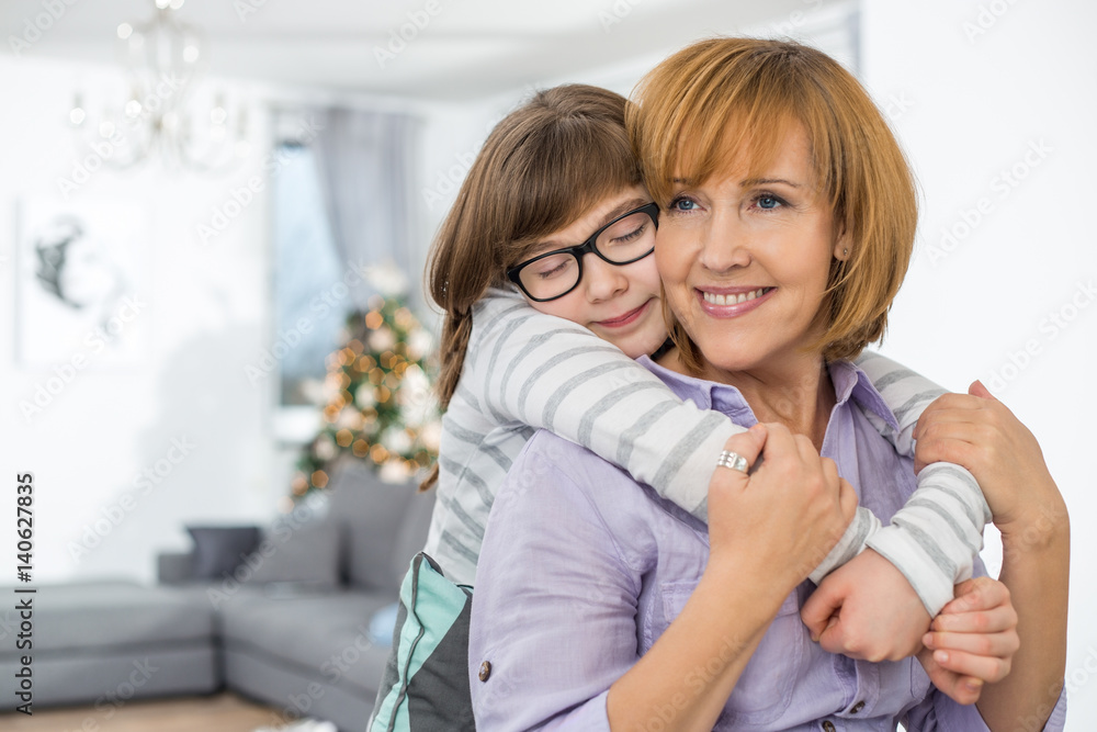 Loving daughter embracing mother at home Loving daughter embracing mother at home
