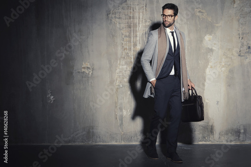 Photos Businessman in suit standing in shadowy studio