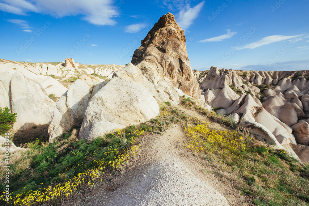 Beautiful Cappadocia on the background of blue sky with white cl Beautiful Cappadocia on the background of blue sky with white cl