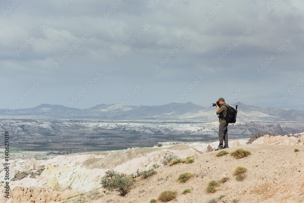 Photographer sandstone cliff and observing the natural landscape