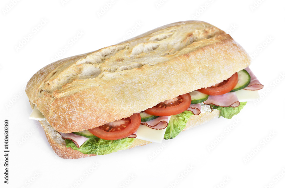 Delicious ciabatta sandwich with ham, tomatoes, fresh salad and cucumber slices. Isolated on white background.