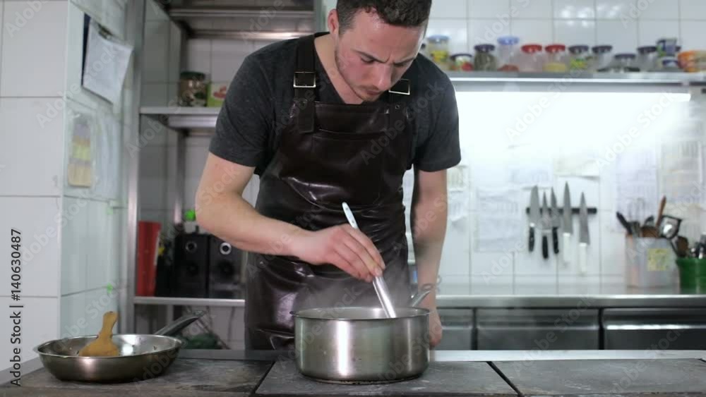 The chef cooks spaghetti on the pro-kitchen The chef cooks spaghetti on the pro-kitchen