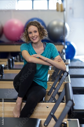 Portrait of woman relaxing on reformer