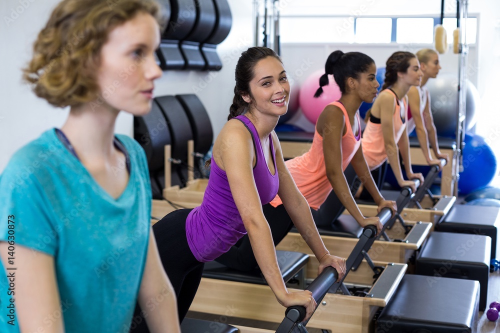 Group of women exercising on reformer Group of women exercising on reformer