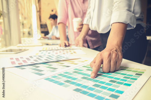 Graphic design and color swatches and pens on a desk. Architectural drawing with work tools and accessories.