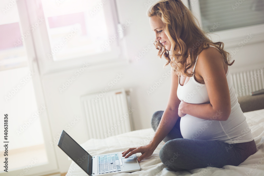 Pregnant expectant woman using technology from home Pregnant expectant woman using technology from home