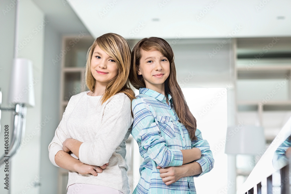 Portrait of cute sisters standing together at home Portrait of cute sisters standing together at home