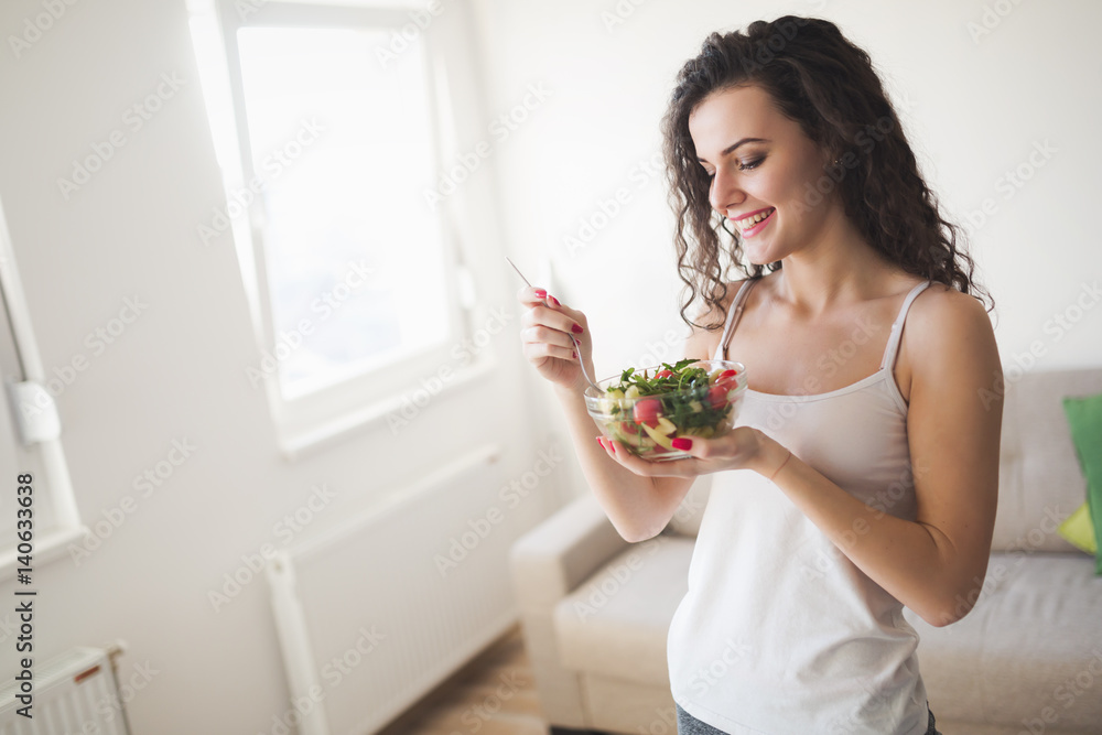 Beautiful fit woman eating healthy salad Beautiful fit woman eating healthy salad