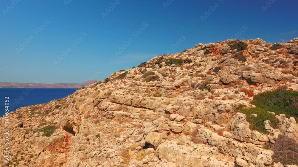 Blue sea, waves breaking in cliffs at shore Blue sea, waves breaking in cliffs at shore