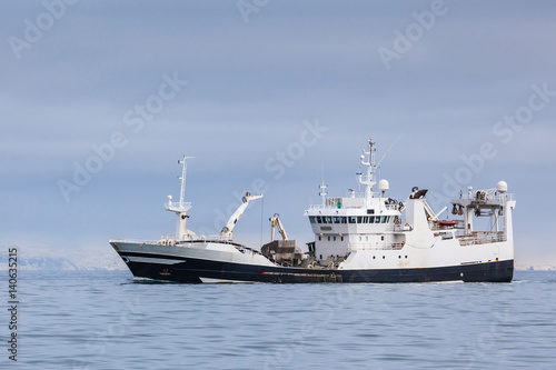 Pelagic fishing vessel fully loaded with Capelin sailing near the coast of Iceland.