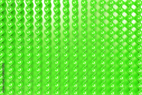 Green plastic spiral sticks on green background