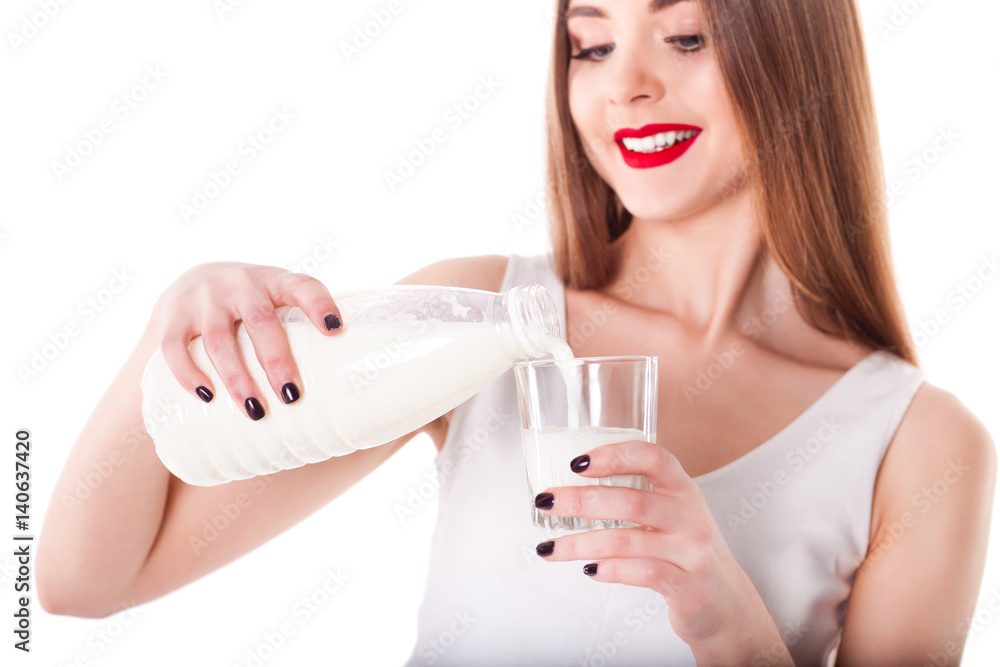 Beautiful model girl holding and pouring milk, on white background isolate, diet and healthy lifestyle Beautiful model girl holding and pouring milk, on white background isolate, diet and healthy lifestyle