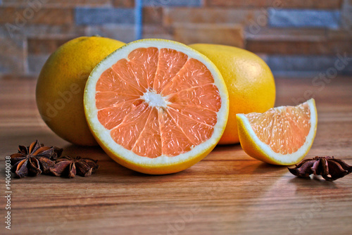 Closeup of grapefruits and star anise on a wooden table