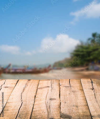 Abstract background with plank wooden empty surface in front of island with boat blurred backdrop