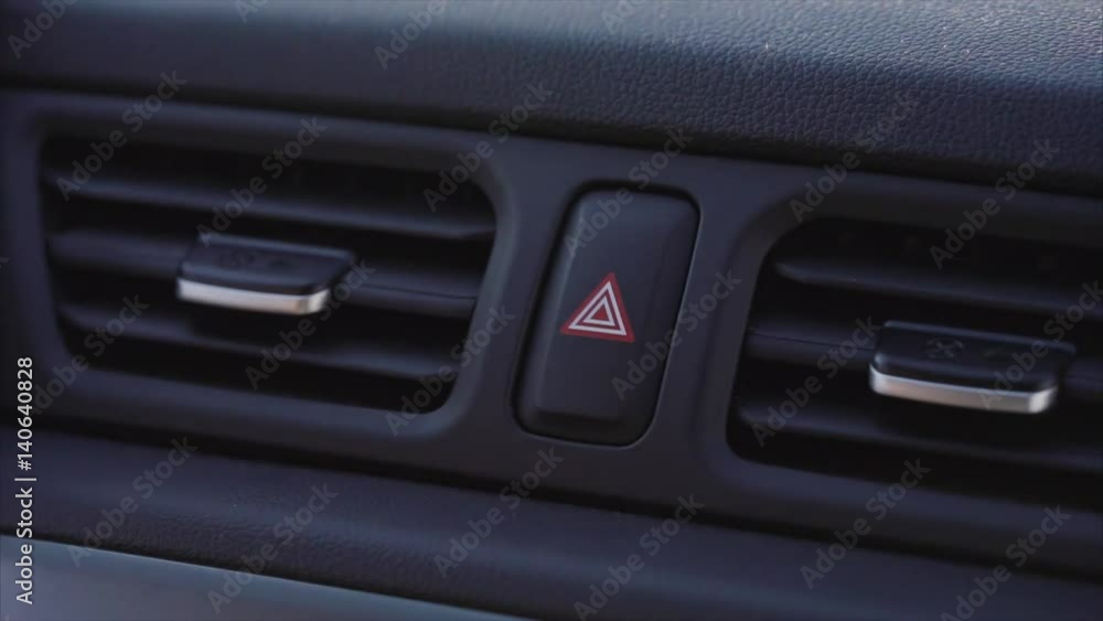 Man presses the alarm button in his car. Man presses the alarm button in his car.