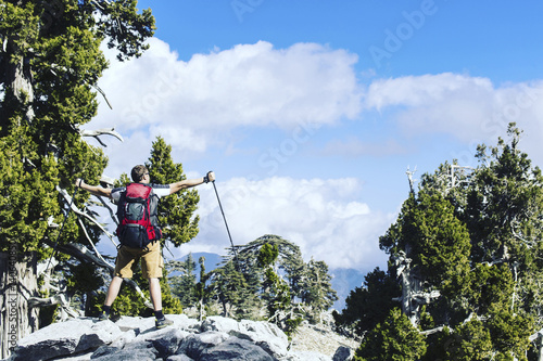 Summer hiking in the mountains with a backpack and tent.