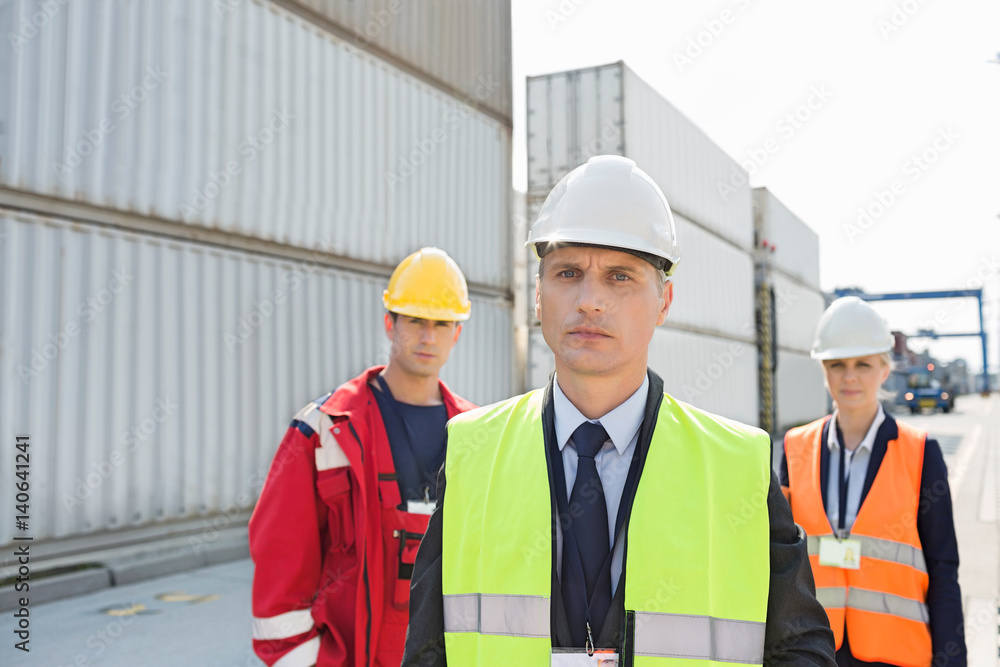 Team of confident workers in shipping yard Team of confident workers in shipping yard