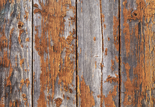 Old weathered red painted wooden wall with flaking off paint, texture pattern