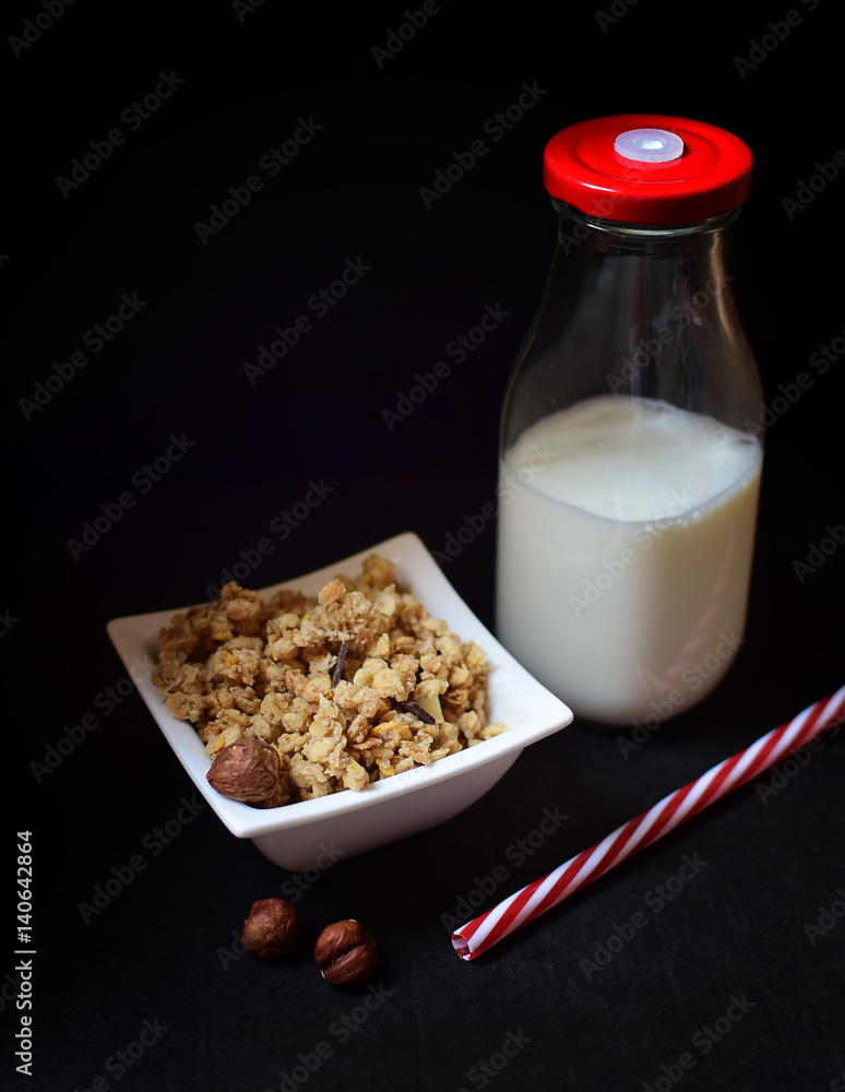 Healthy breakfast - milk and musli on dark background Healthy breakfast - milk and musli on dark background