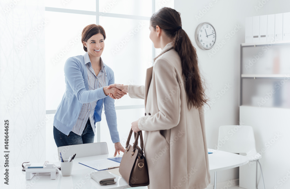 Fototapeta premium Businesswoman giving an handshake