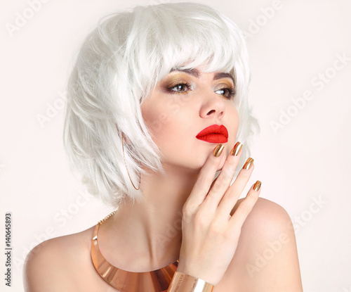 Blonde bob hairstyle. Blond hair. Fashion Beauty Girl portrait. Red lips. Manicured nails and Make-up. Jewelry set. Vogue Style Woman isolated on white background.