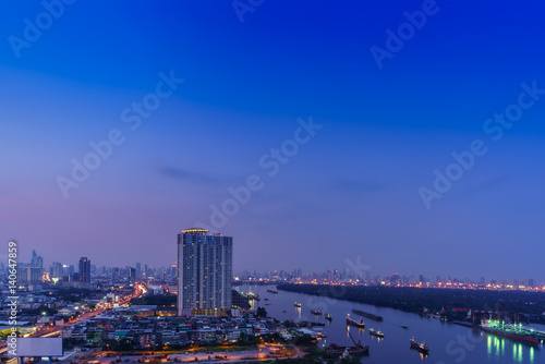 Cityscape of Bangkok in twilight viewing Rama III road along Chao Phraya river   Thailand