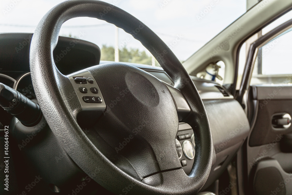 Steering wheel and modern vehicle interior, inside car 
