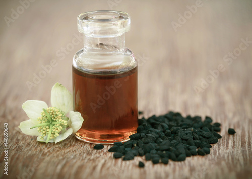 Nigella flower with seeds and essential oil
