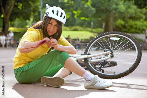 Fotografie Young woman injured and clutching arm