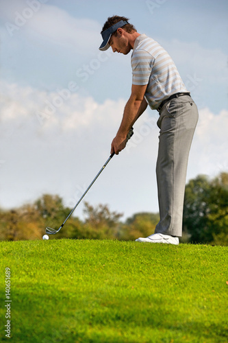 Young man playing golf