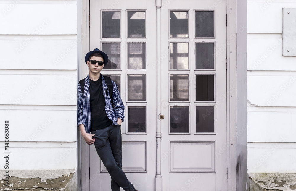 Stylish young man near the doors of the building Stylish young man near the doors of the building