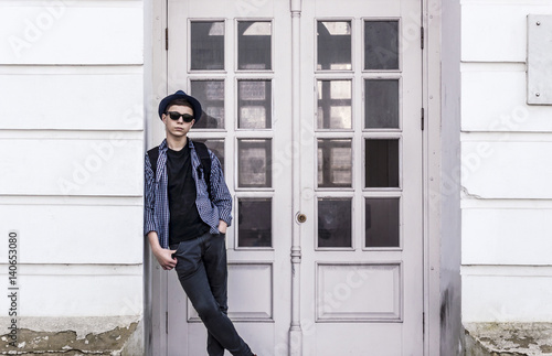 Stylish young man near the doors of the building © Yalana