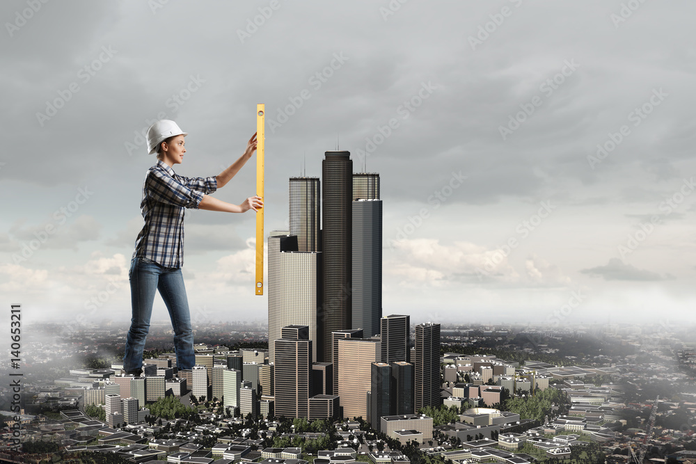 Builder woman taking measures . Mixed media Builder woman taking measures . Mixed media