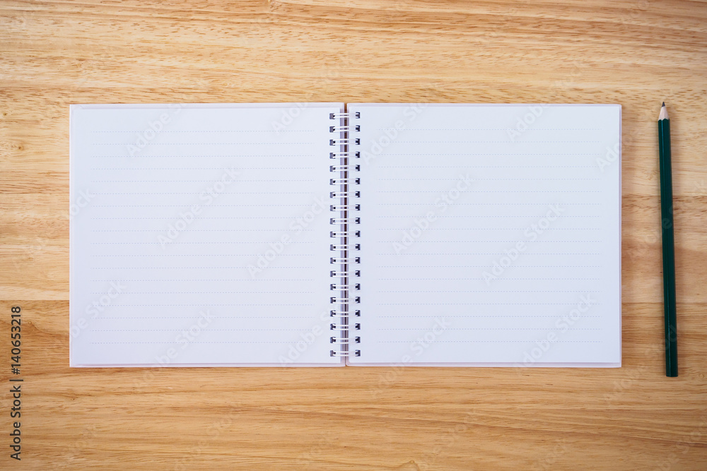 notebook top view with pencil on brown wood desk notebook top view with pencil on brown wood desk